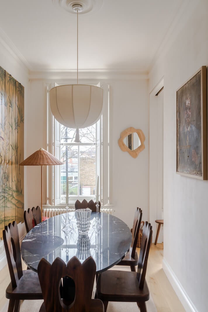 Cozy Contemporary Spaces in a Light-Filled Victorian Apartment 12 dining room oval table marble top