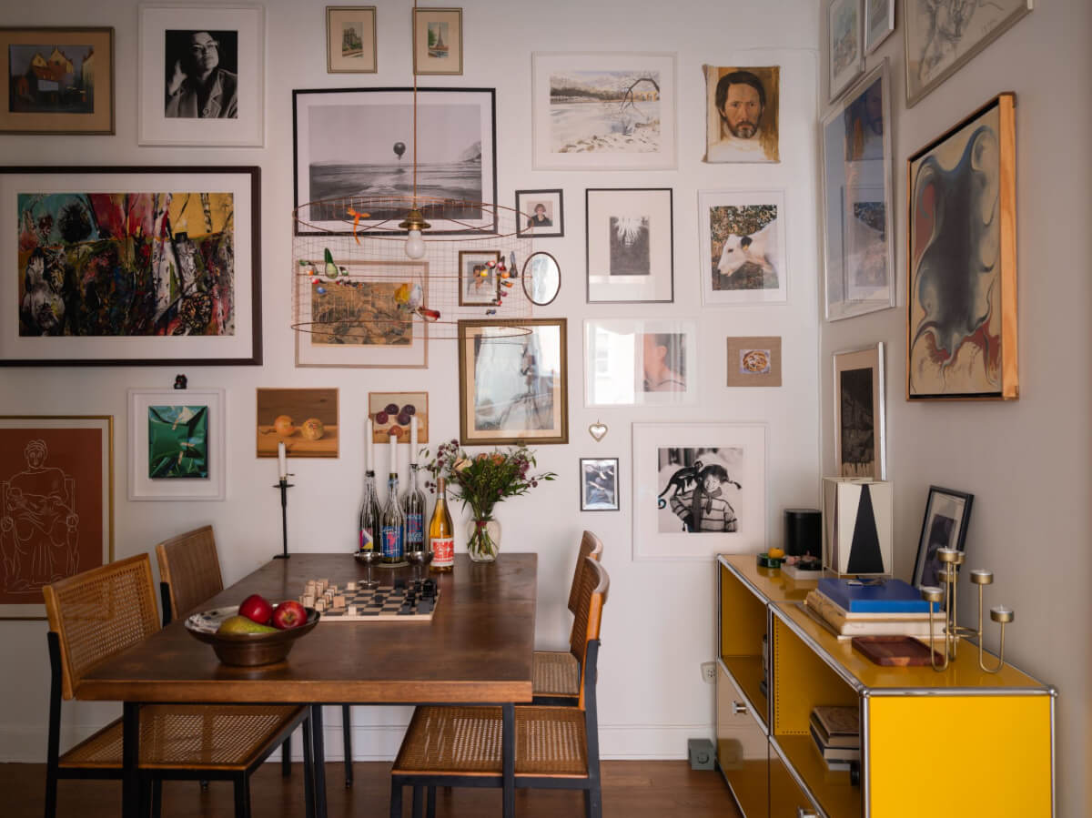 An Airy One-Bedroom Apartment with Art and A Yellow Kitchen 13 dining room with gallery wall