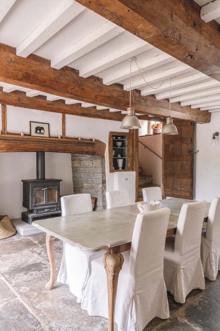 A Beautiful Renovated Country House in England 10 dining room wooden beams wood burner