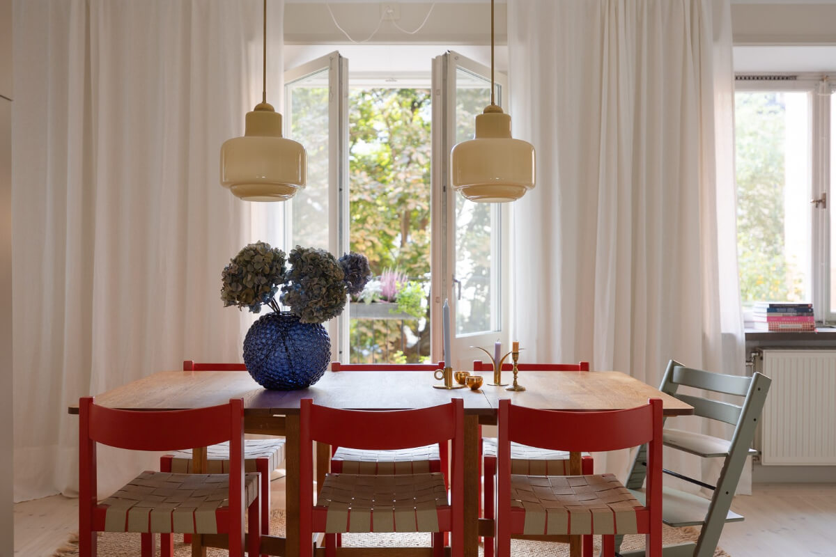 Modern Interiors in a Bright 1930s Apartment in Sweden 7 dining table with red chair