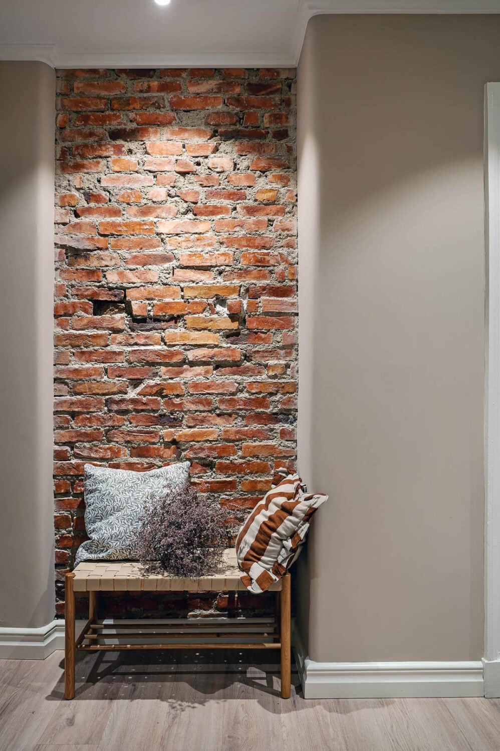 Warm and Inviting Rooms in a Renovated Swedish Apartment 31 exposed brick wall and bench