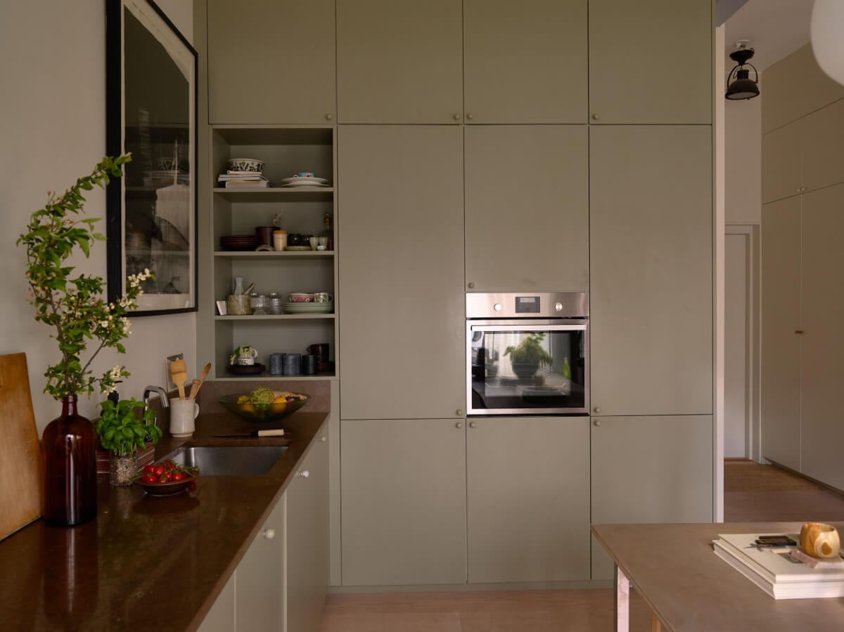 High Ceilings in a Small Swedish Loft Designed for a Family 5 floor to ceiling green cabinets