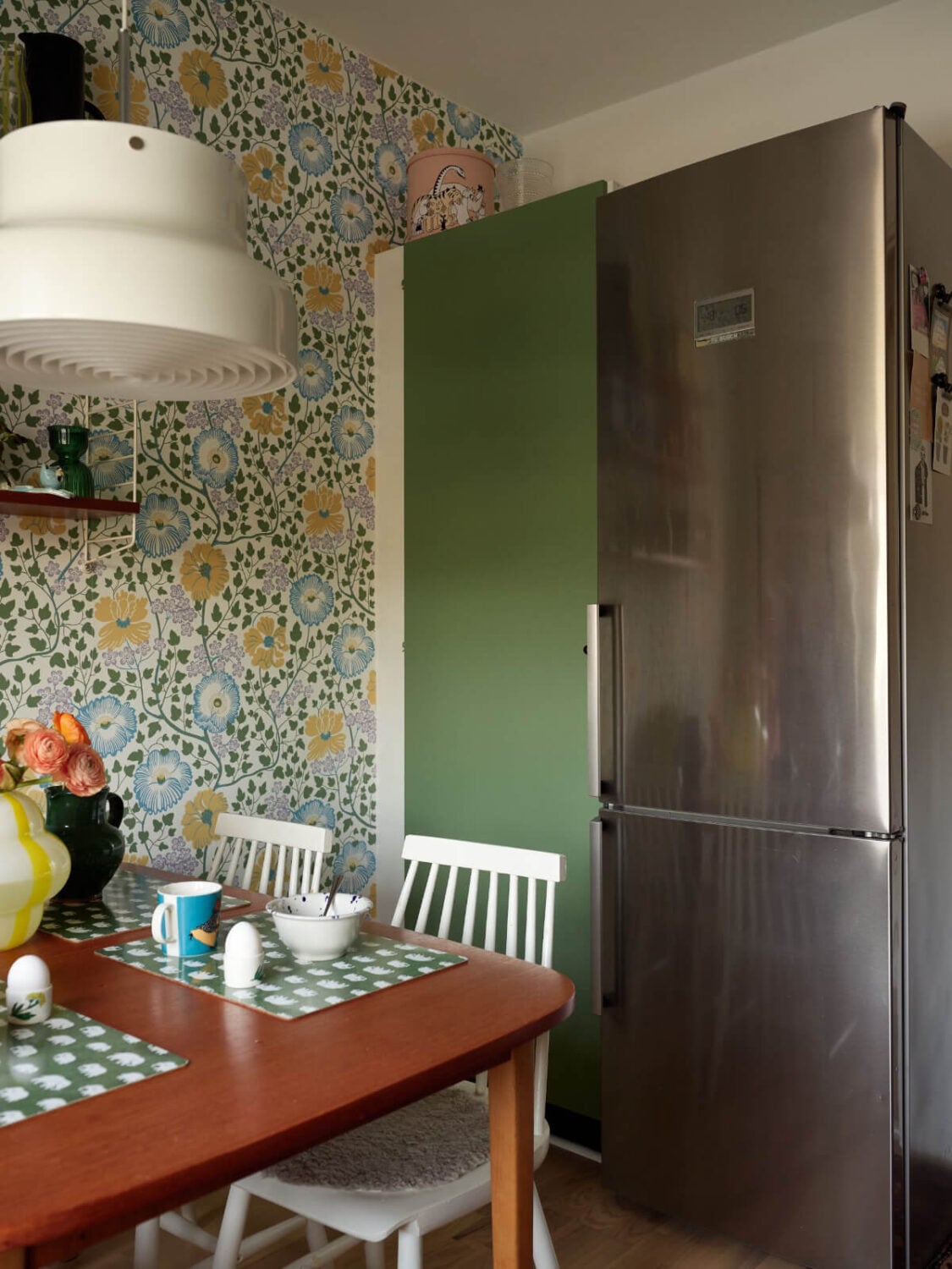 A Colorful Midcentury Apartment Filled with Art and Plants 12 floral wallpaper kitchen table