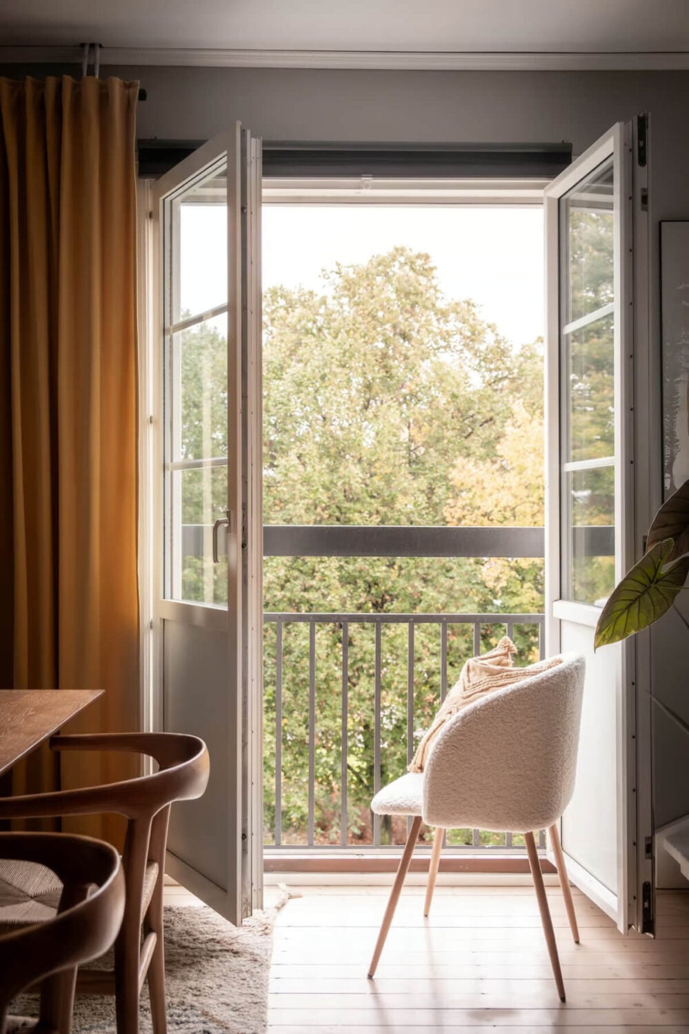 A Swedish Attic Apartment with Exposed Brick and Yellow Color Accents 3 french balcony