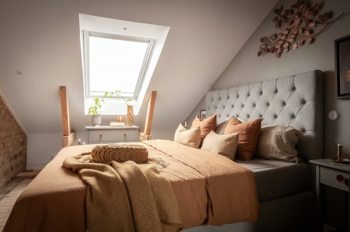 A Swedish Attic Apartment with Exposed Brick and Yellow Color Accents 19 gray attic bedroom with warm earthy textiles