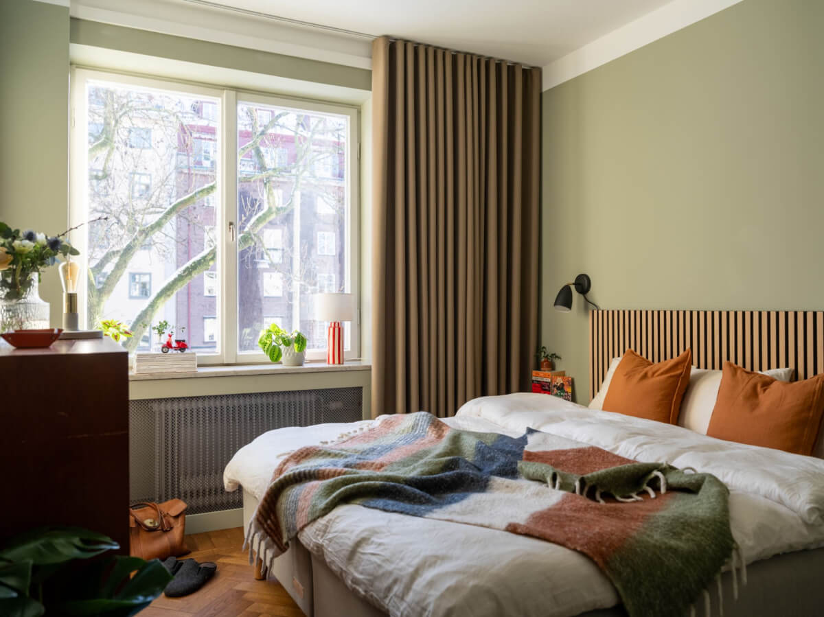 A Light, Renovated Two-Bedroom Apartment in Stockholm 12 gray-green bedroom wooden headboard