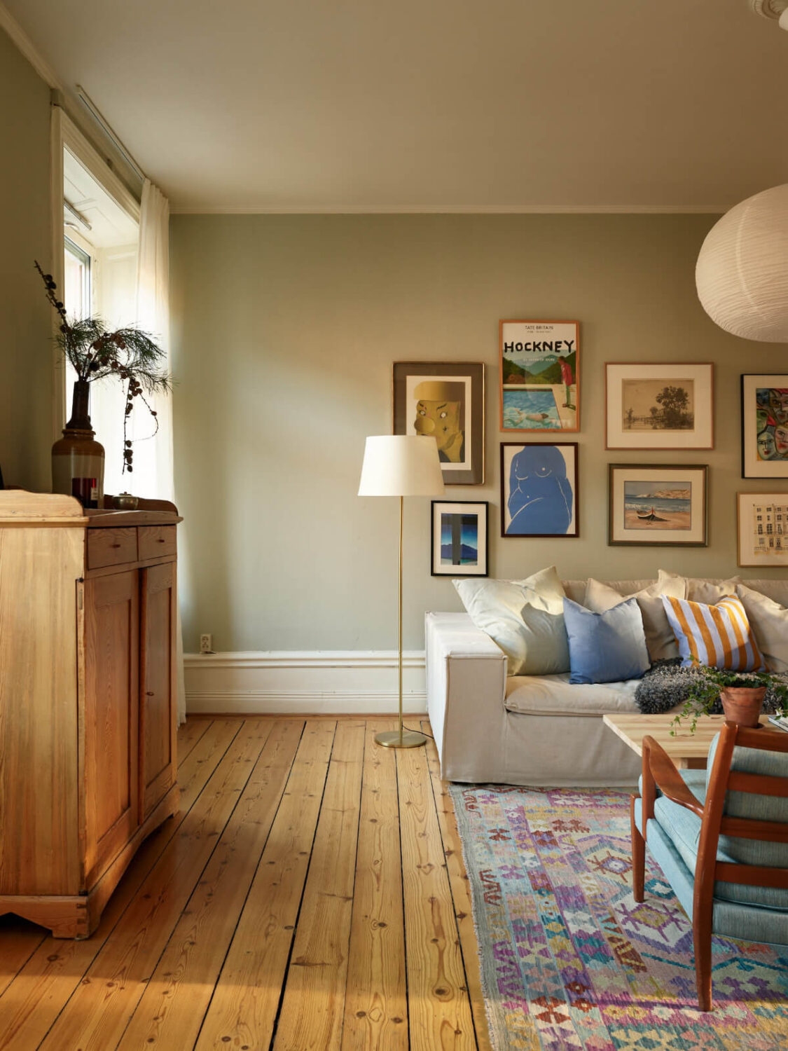 A Charming Historic Stockholm Apartment with a Blue Kitchen 19 gray-green walls living room wooden floor