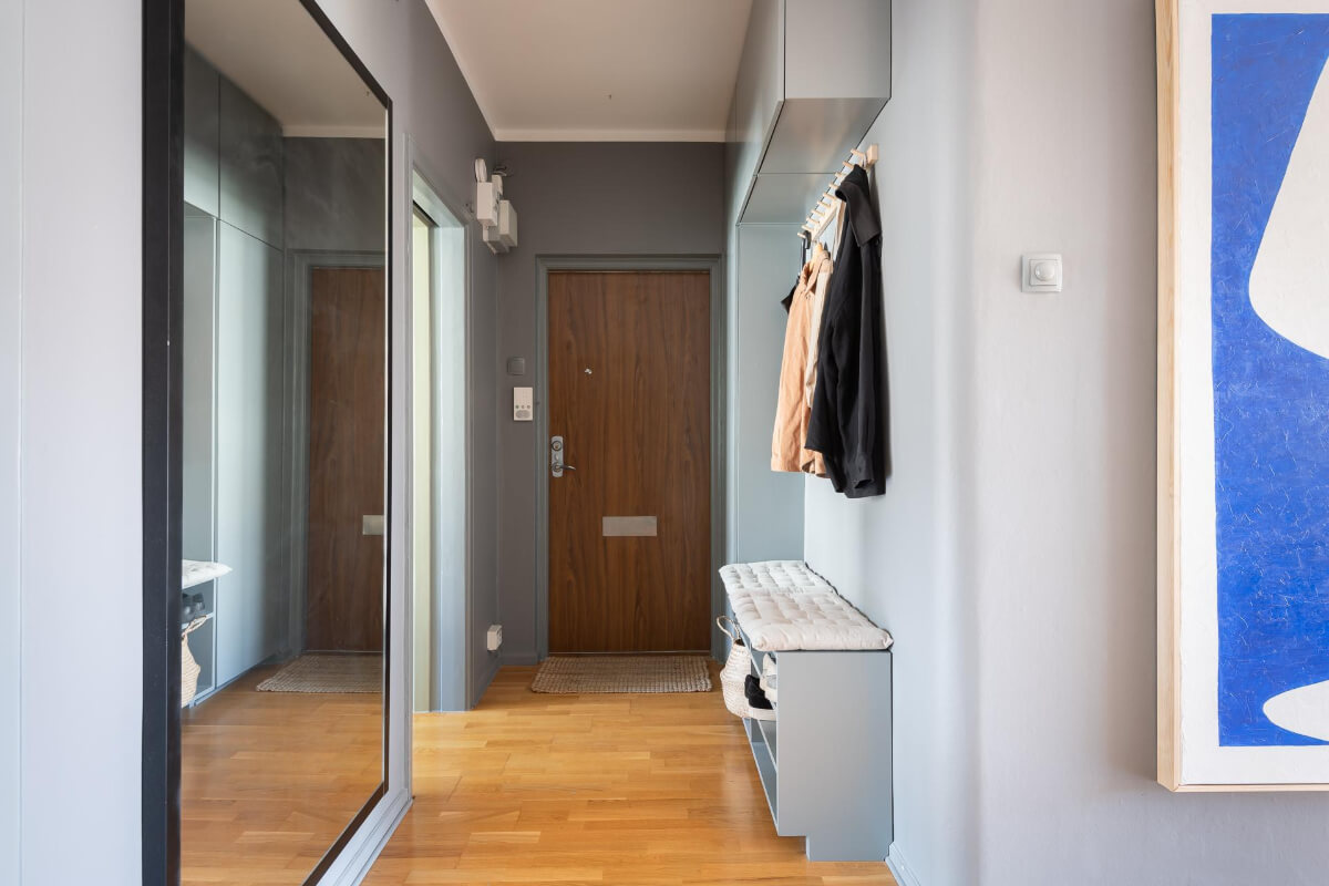 Light Rooms and a Moody Color Palette in a 1930s Apartment 27 gray hall with storage large mirror Light Rooms and a Moody Color Palette in a 1930s Apartment
