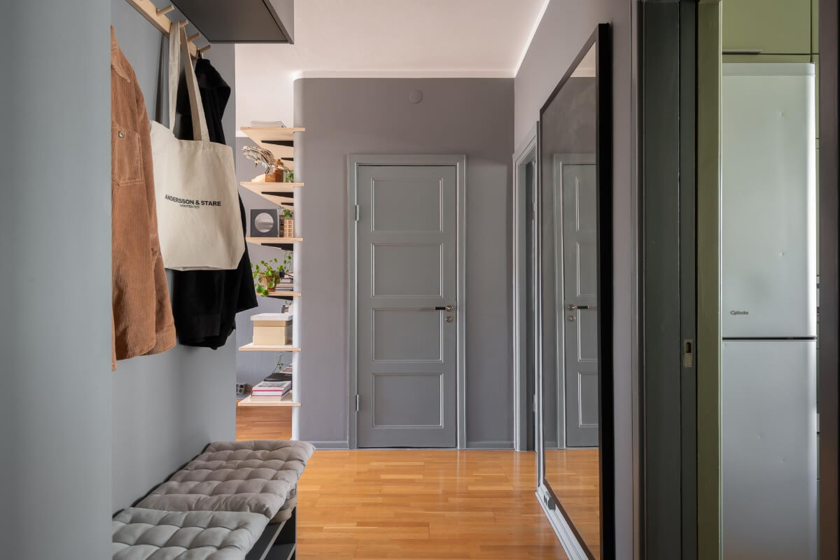 Light Rooms and a Moody Color Palette in a 1930s Apartment 25 gray hallway