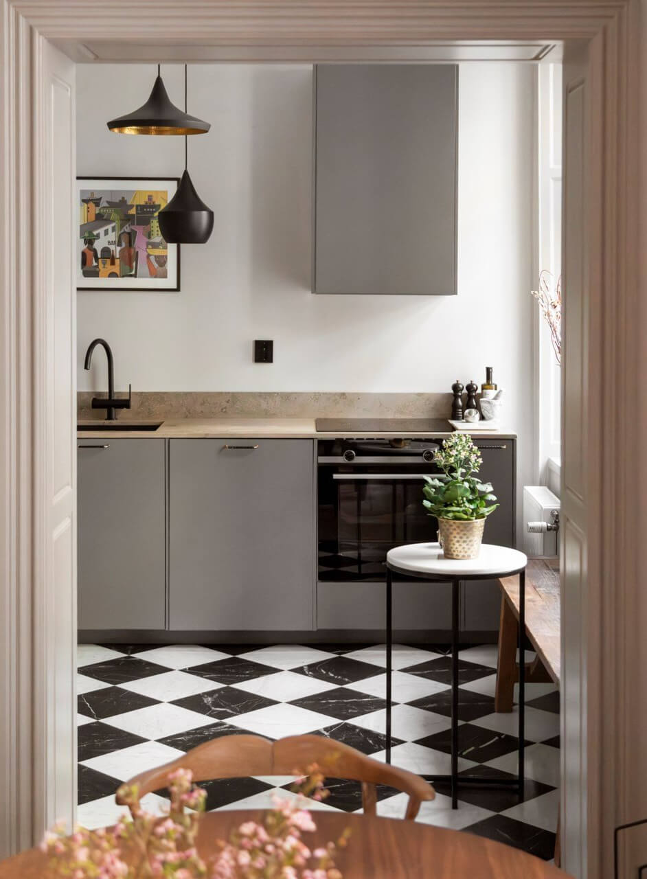 A Stylish Two-Bedroom Apartment in Stockholm 9 gray kitchen checkerboard tile floor tiny table