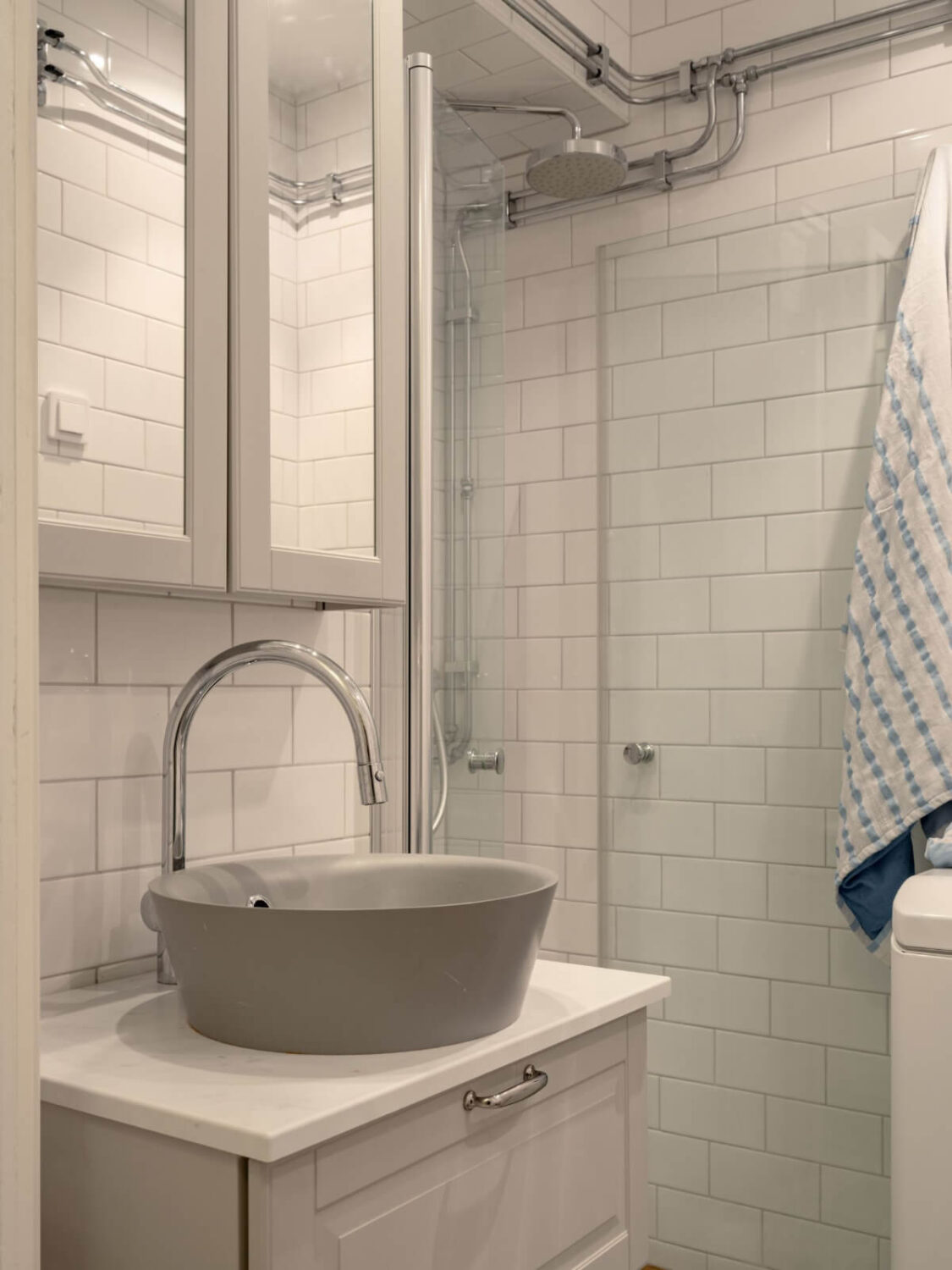 A Small Apartment with High Ceilings and a Large Bay Window 23 gray sink tiny bathroom