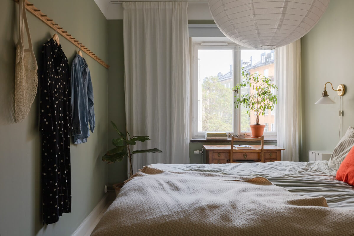 Modern Interiors in a Bright 1930s Apartment in Sweden 22 green bedroom antique desk