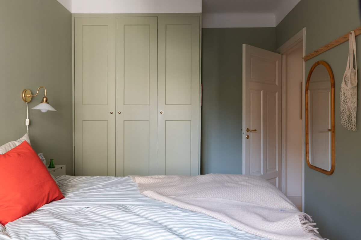 Modern Interiors in a Bright 1930s Apartment in Sweden 25 green bedroom built-in wardrobes