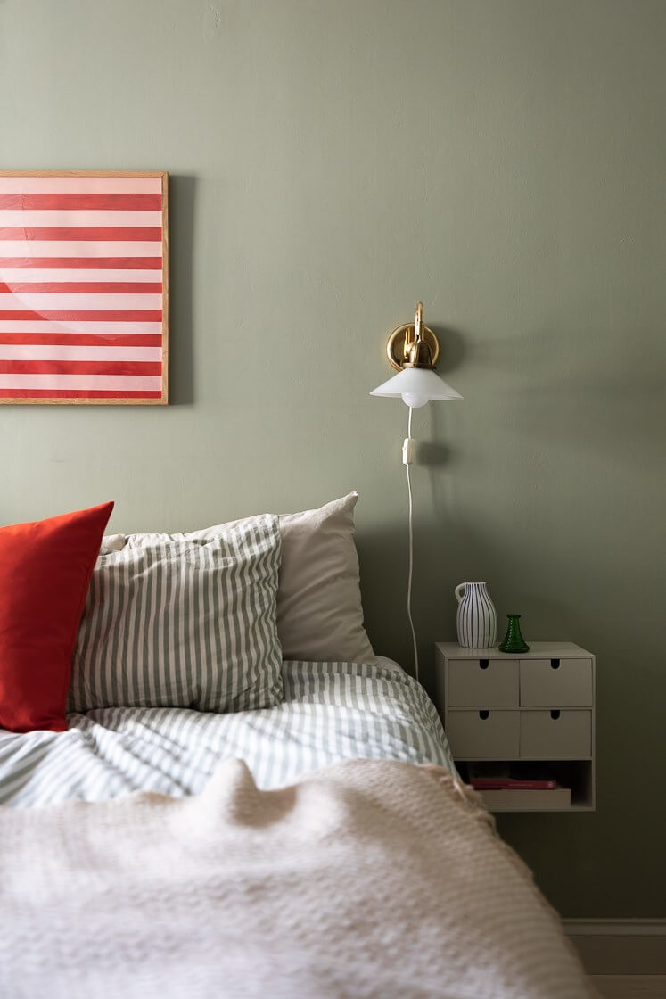 Modern Interiors in a Bright 1930s Apartment in Sweden 23 green bedroom floating nightstand cabinet