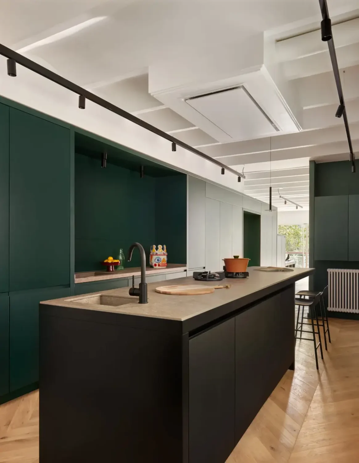 A Modern Barcelona Apartment with a Pink Bathroom 12 green cabinets kitchen with island