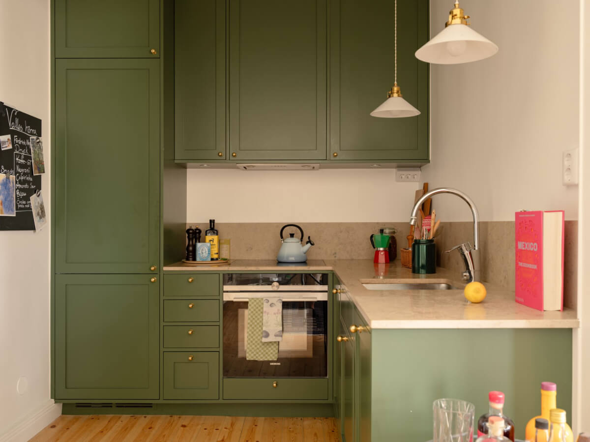 A Small Apartment with High Ceilings and a Large Bay Window 19 green kitchen cabinets