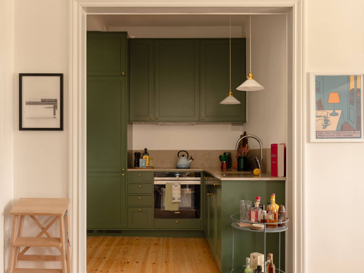 A Small Apartment with High Ceilings and a Large Bay Window 17 green kitchen limestone countertop