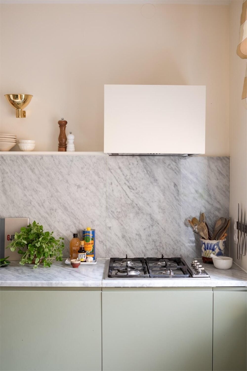A Light-Filled Two Bedroom Apartment in Stockholm 8 green kitchen marble countertop backsplash detail