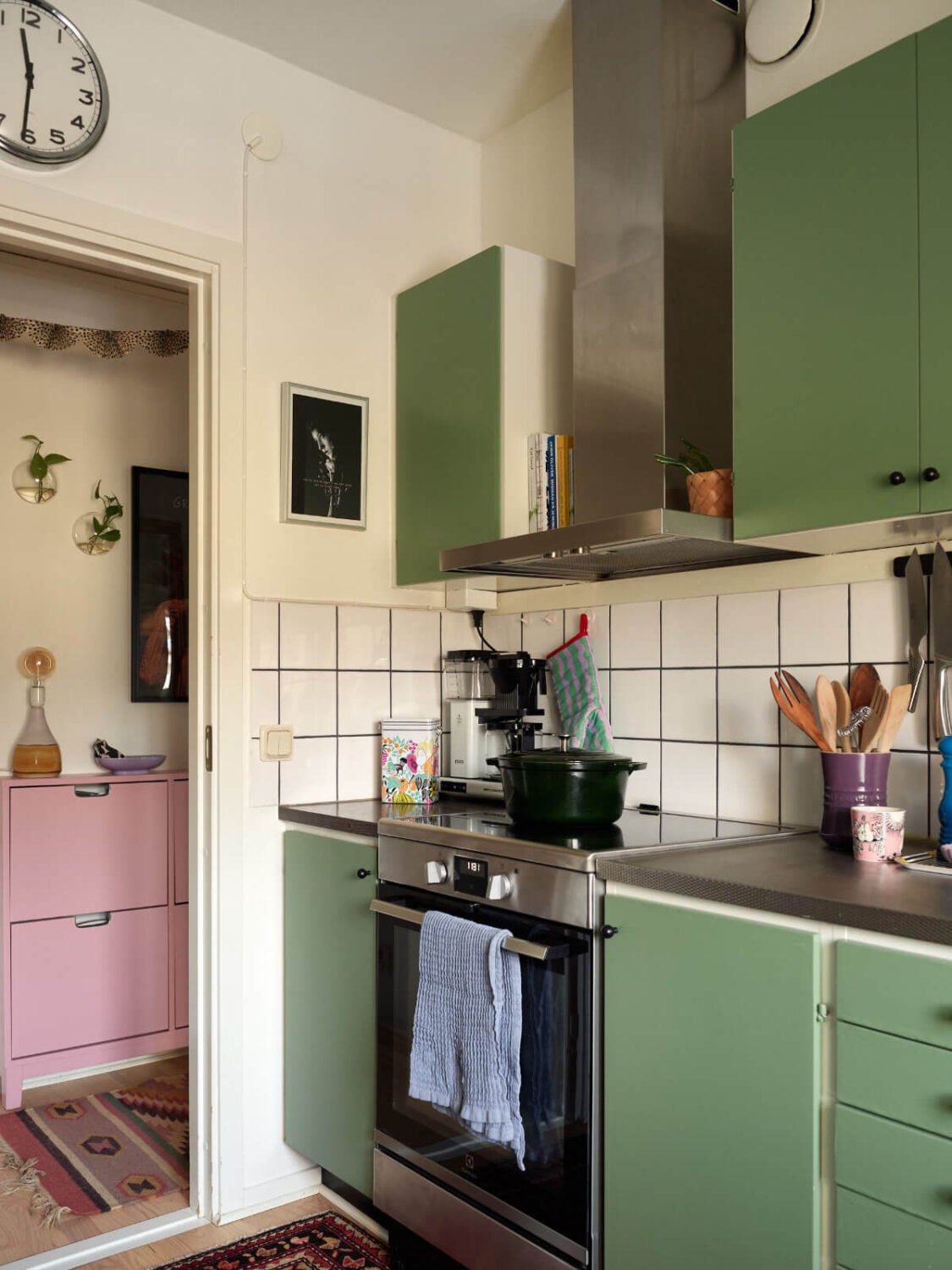 A Colorful Midcentury Apartment Filled with Art and Plants 14 green kitchen white tiles
