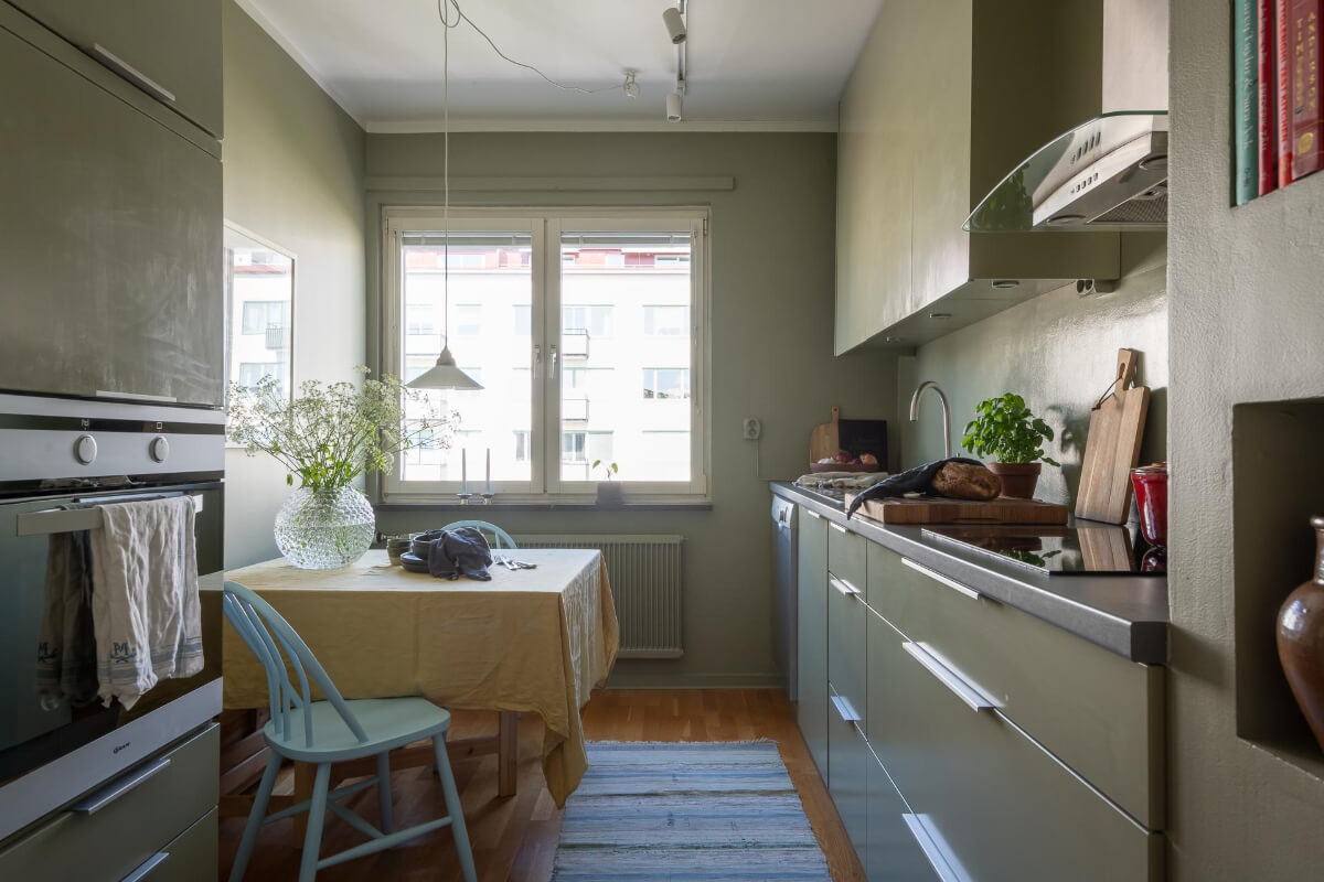 Light Rooms and a Moody Color Palette in a 1930s Apartment 16 green kitchen with square table