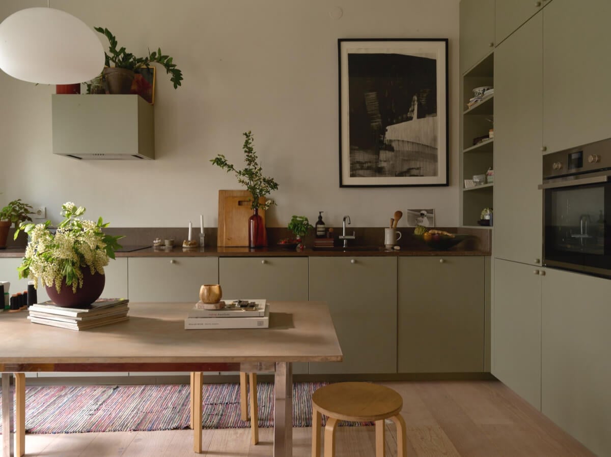 High Ceilings in a Small Swedish Loft Designed for a Family 2 green kitchen