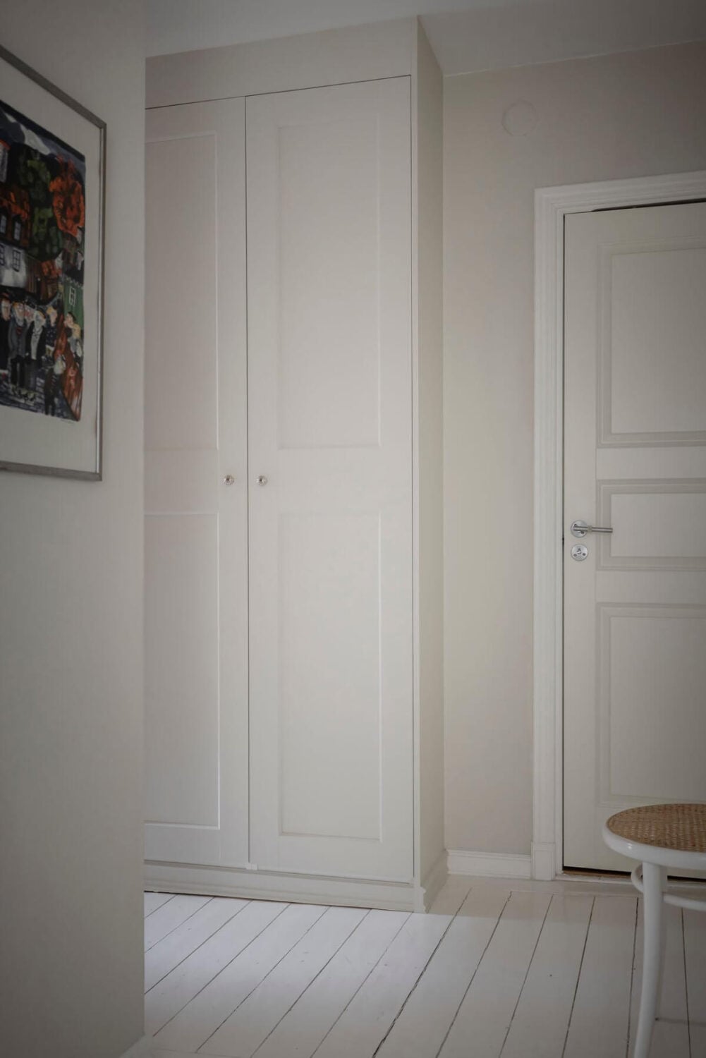 White-Painted Floorboards in a Turn-of-the-Century Apartment 19 hall built-in wardrobes