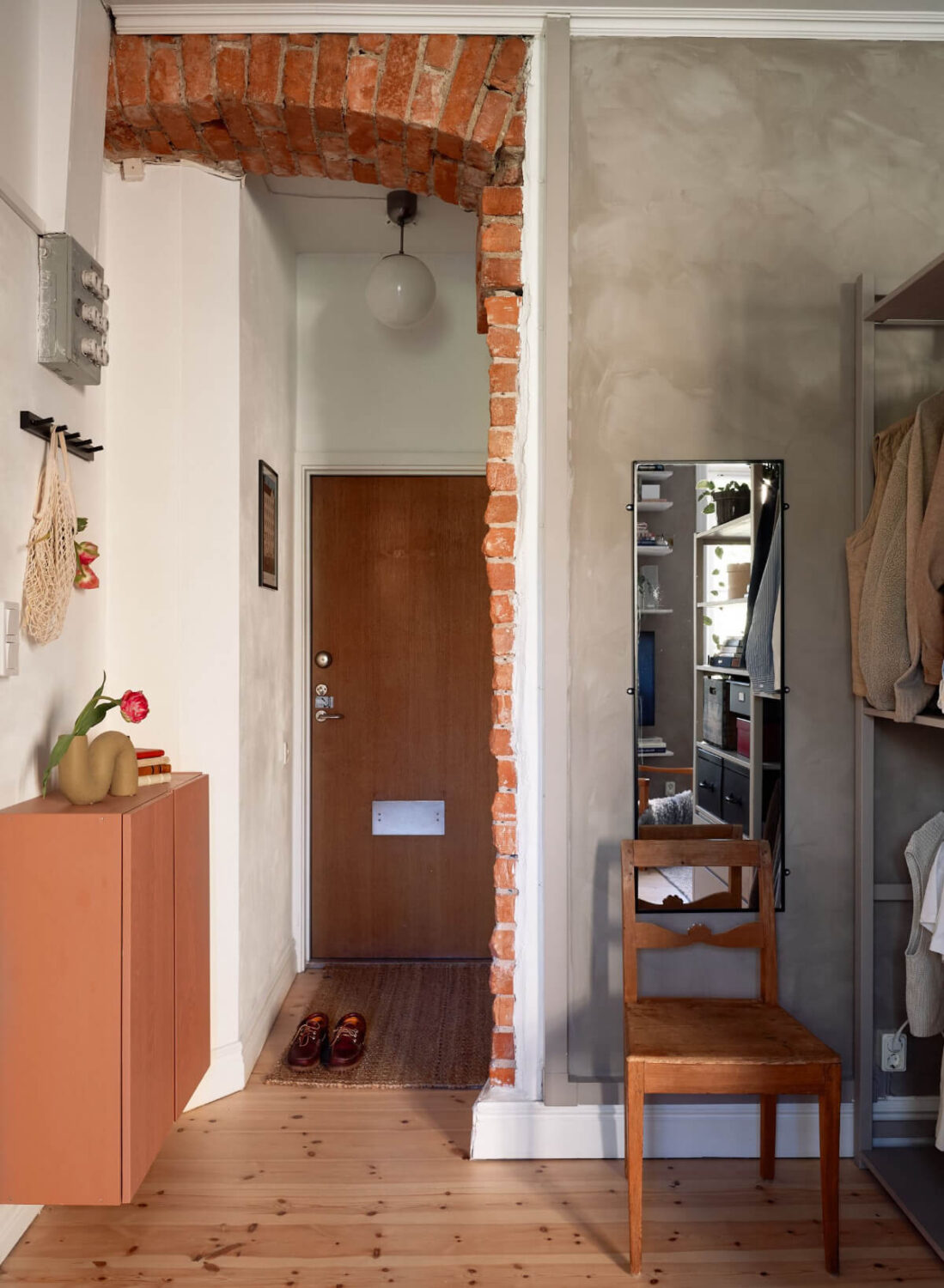 A Studio Apartment with Smart Storage Ideas and Exposed Brick 12 hall exposed brick doorway