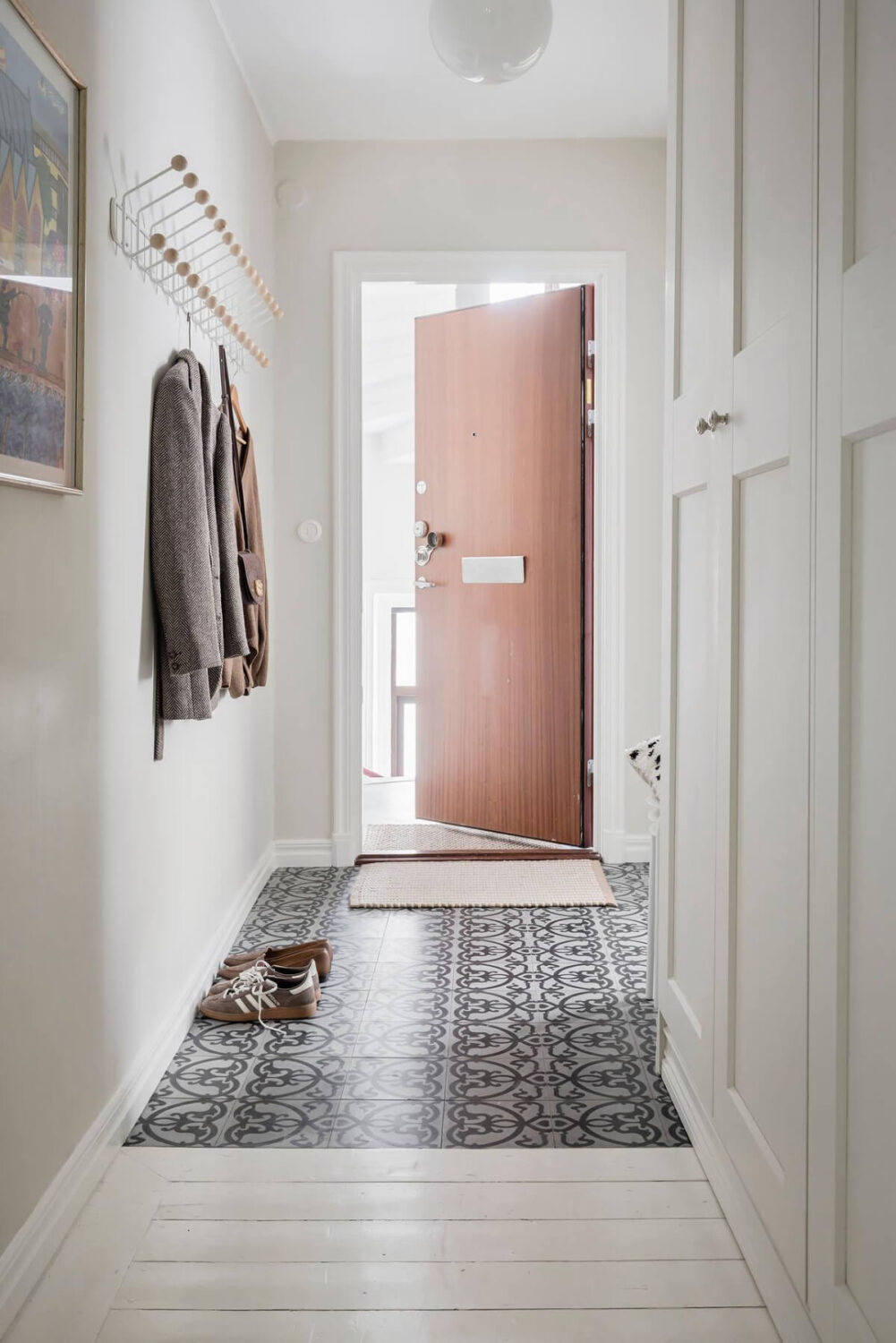 White-Painted Floorboards in a Turn-of-the-Century Apartment 27 hall patterned tiles