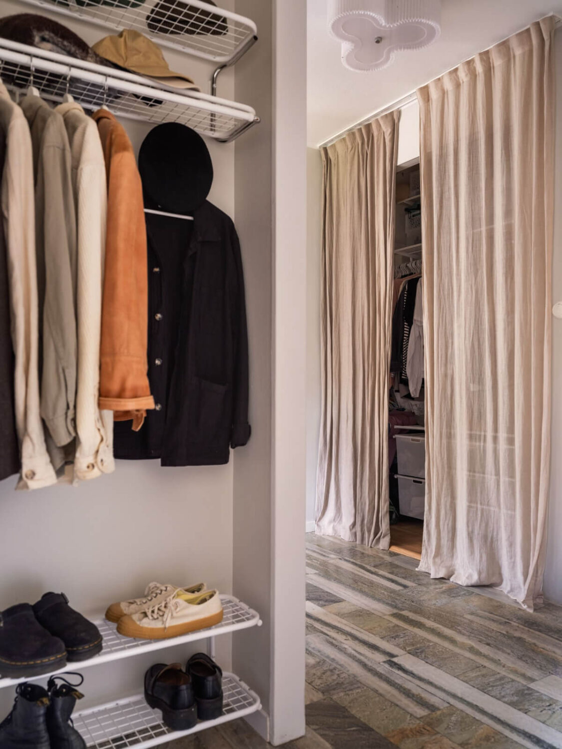 A Swedish 1940s Apartment with Lovely Balcony Views 17 hall stone floor built-in closet space with curtain