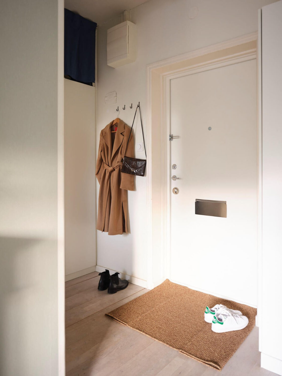 A Small Stockholm Apartment with a Tiny Green Bedroom 18 hall with coat hangers