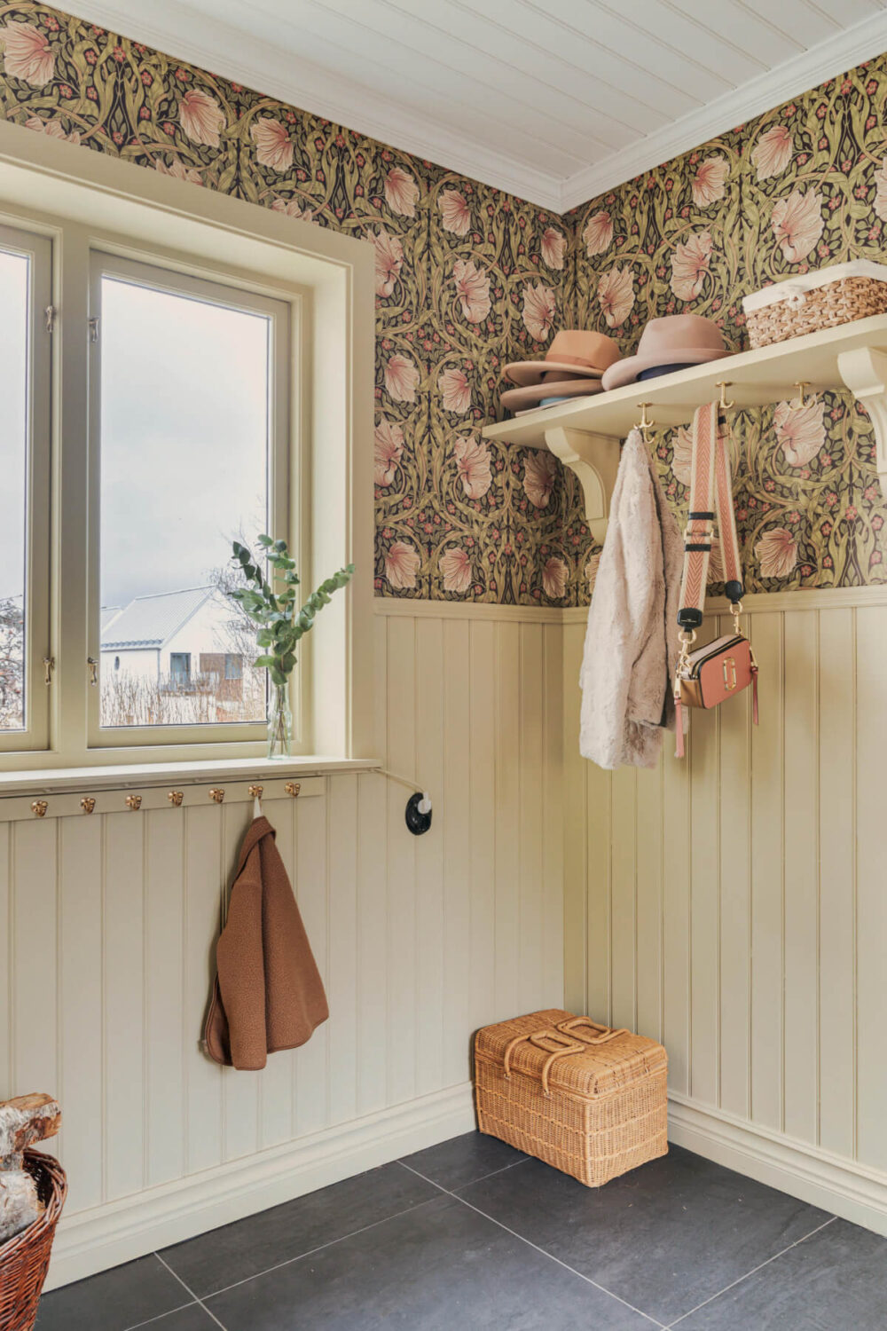 A Charming Home with Lake Views South of Stockholm 11 hall with hat shelf tongue and groove paneling and william morris wallpaper