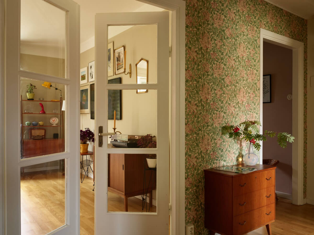 A Charming Midcentury Apartment with Original Features 8 hall with wallpaper and double glass doors