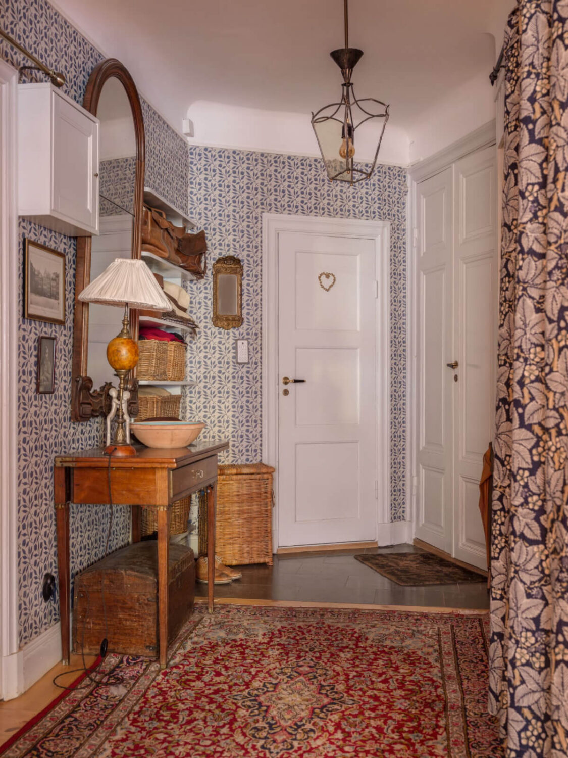 A Charming Home in a 17-Century Apartment in Stockholm's Old Town 29 hall with wallpaper and large rug