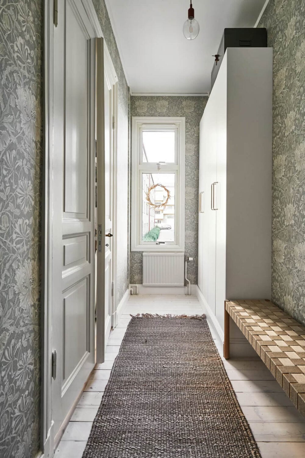 A Bright Turn-of-the-Century Apartment in Sweden 13 hall with wardrobes and wallpaper