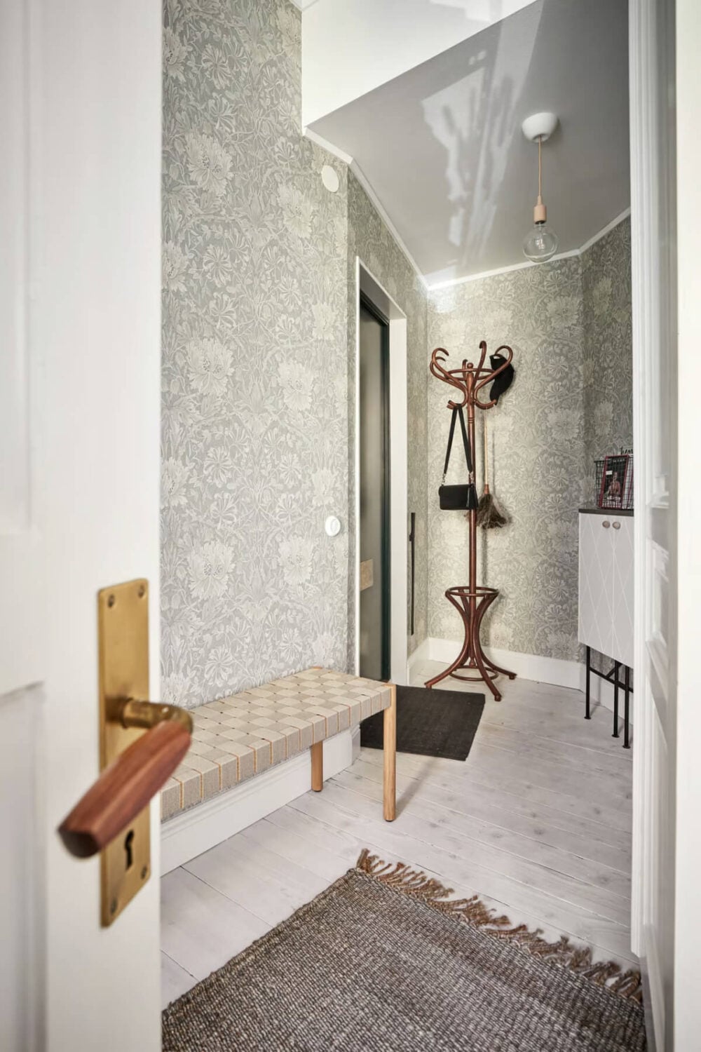 A Bright Turn-of-the-Century Apartment in Sweden 14 hall with william morris wallpaper