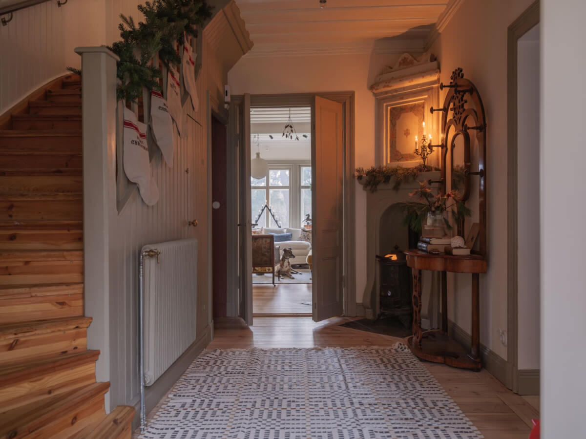 A Beautiful Turn-of-the-Century Family Home in Sweden 27 hall wooden stairs antique table large rug