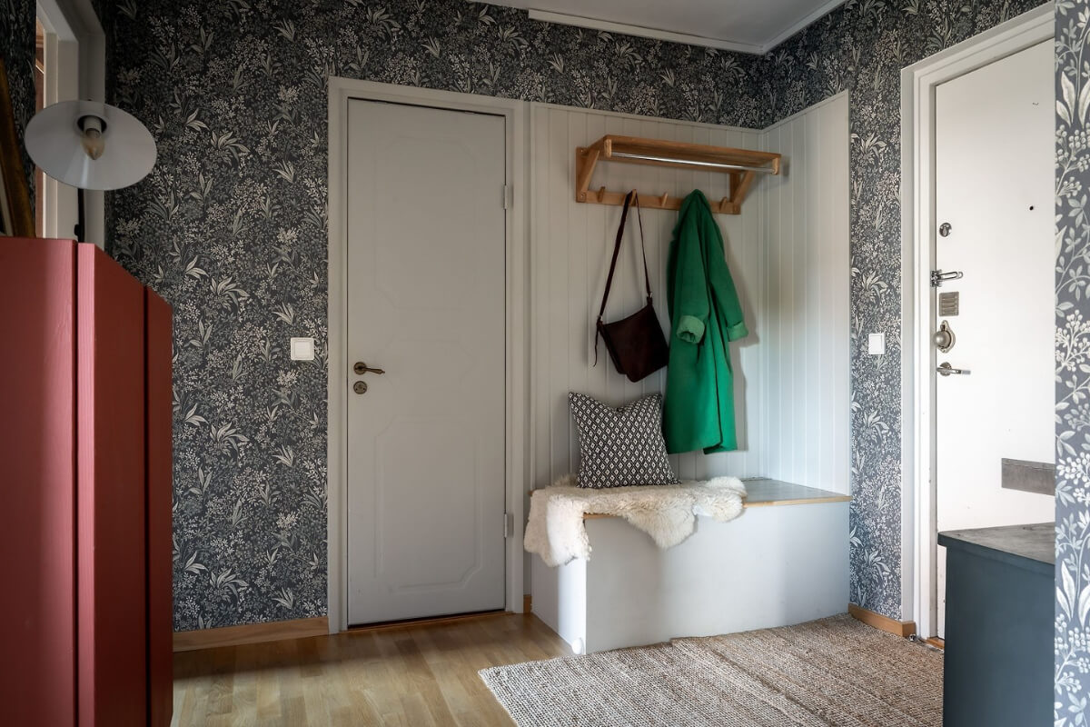A Charming Apartment with Large Windows and Colorful Bedrooms 17 hallway blue wallpaper