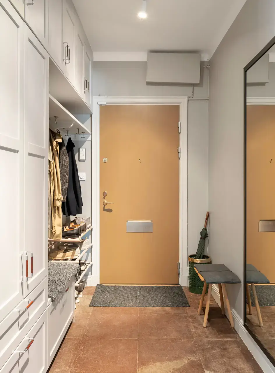 A Charming Ground Floor Family Apartment in Stockholm 22 hallway built in cabinets bench