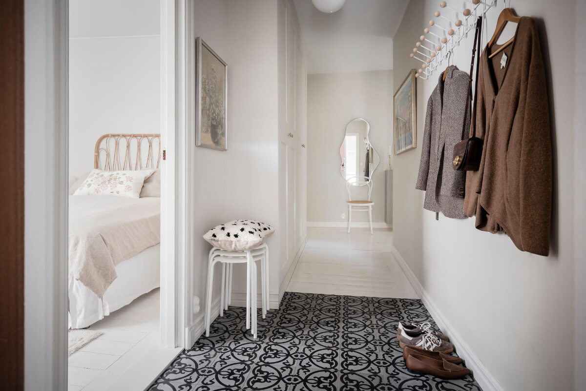 White-Painted Floorboards in a Turn-of-the-Century Apartment 22 hallway coat hangers