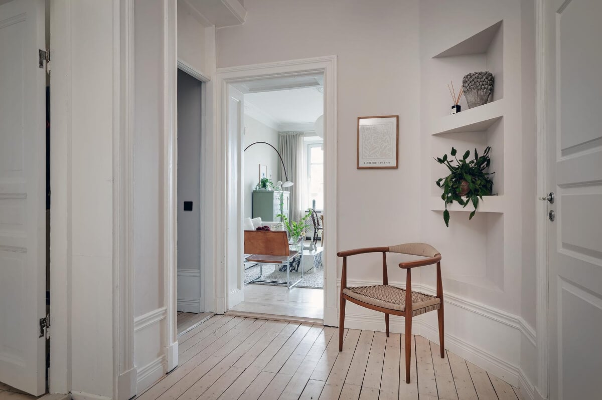 Period Features and Modern Materials in a Swedish Apartment 29 hallway corner shelves