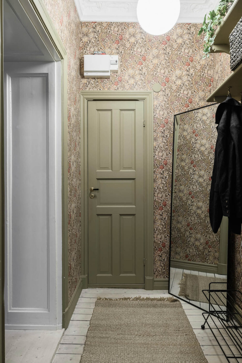Limewash Wall and Period Features in a Swedish Apartment 22 hallway floral wallpaper green door