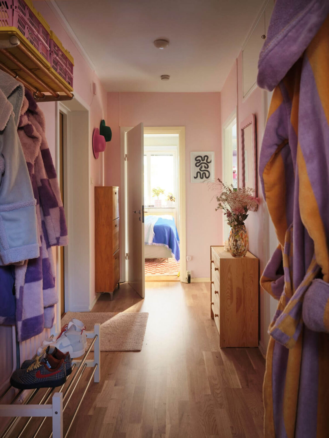 A Midcentury Swedish Apartment with Bright Color Accents 18 hallway light pink walls A Midcentury Swedish Apartment with Bright Color Accents