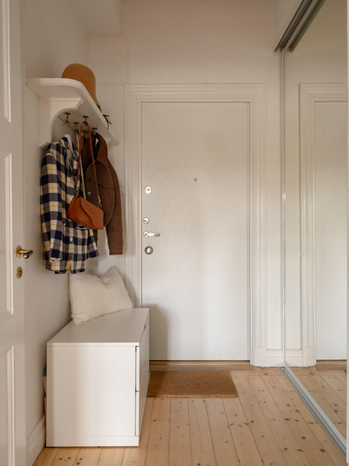 A Small Apartment with High Ceilings and a Large Bay Window 24 hallway mirror wardrobes bench coat storage A Small Apartment with High Ceilings and a Large Bay Window