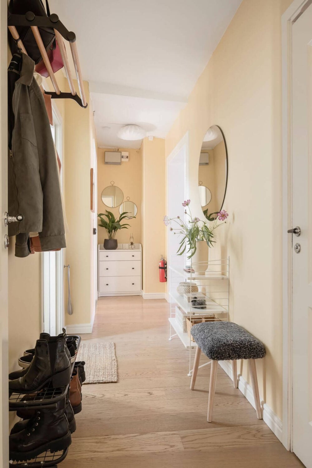 Bright Rooms with Light Color Tones in a Swedish Apartment 27 hallway soft yellow walls