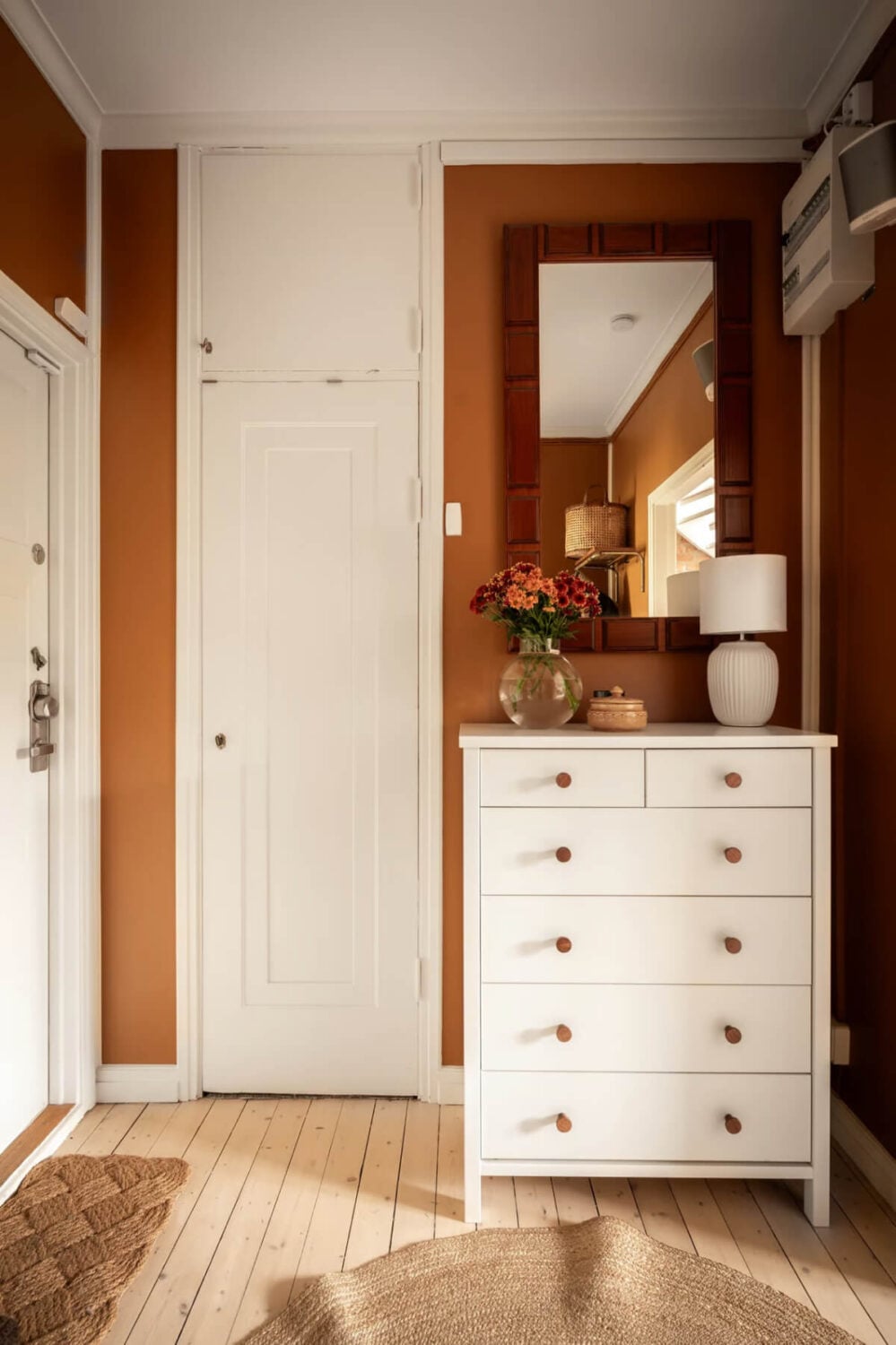A Swedish Attic Apartment with Exposed Brick and Yellow Color Accents 21 hallway with brown walls