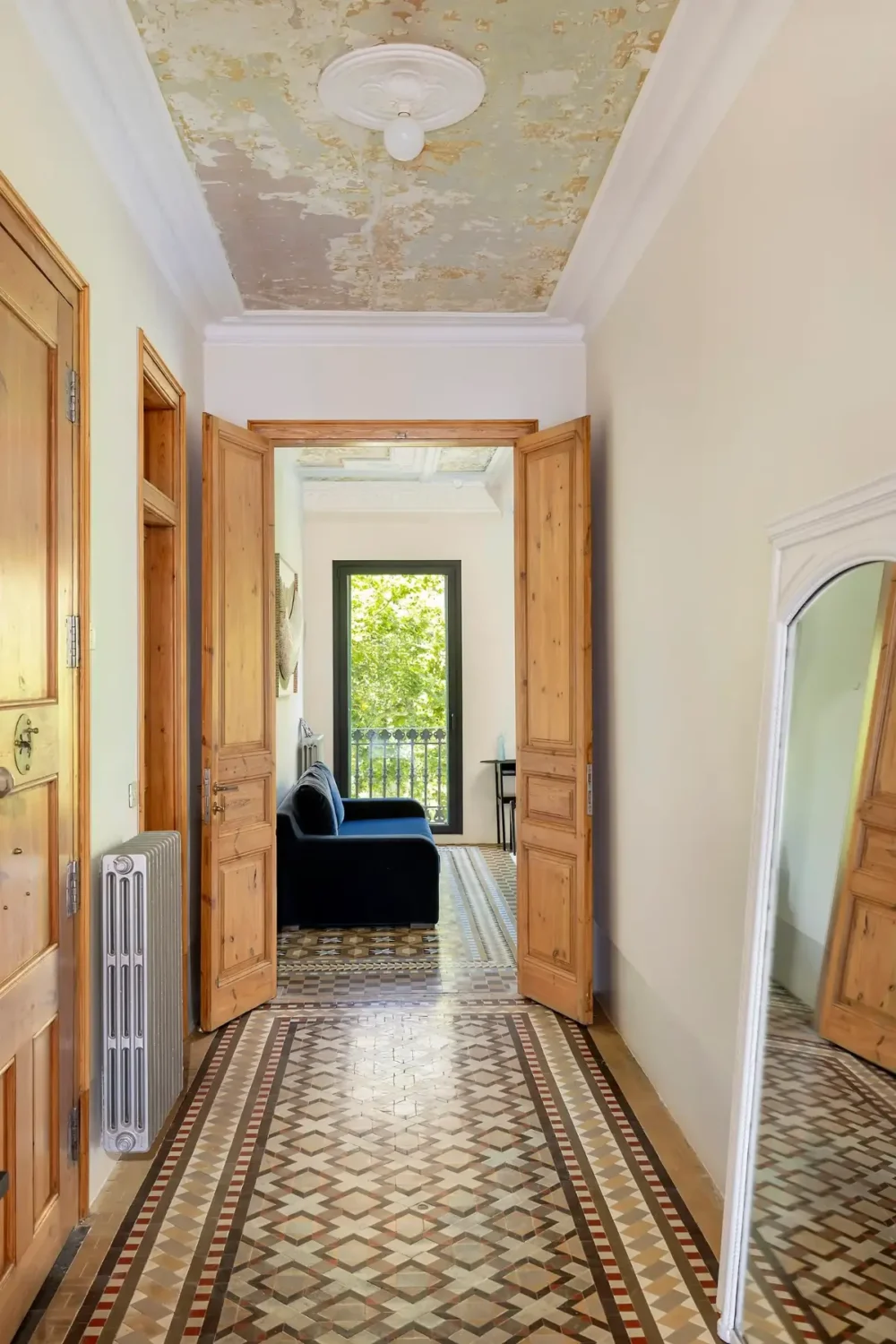 Historic Architecture and Modern Design in a Barcelona Apartment 7 hallway wooden doors tile floor