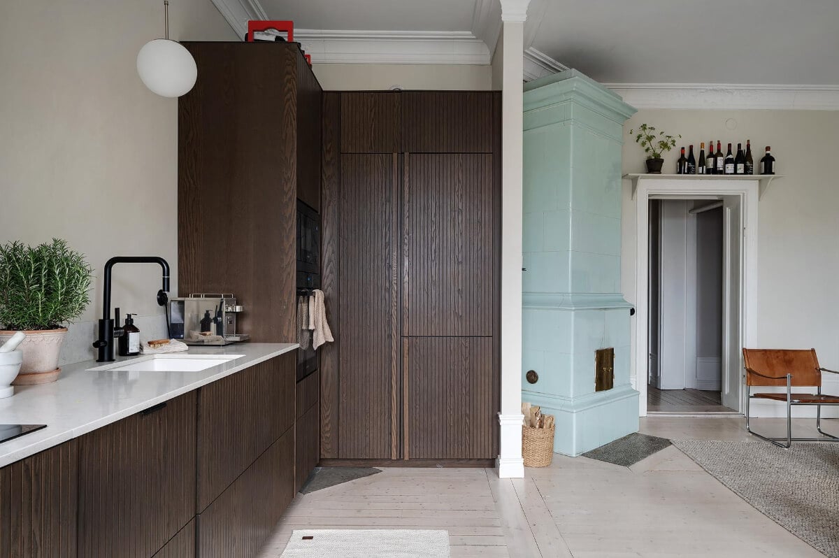 Period Features and Modern Materials in a Swedish Apartment 14 high kitchen cabinets open plan living space