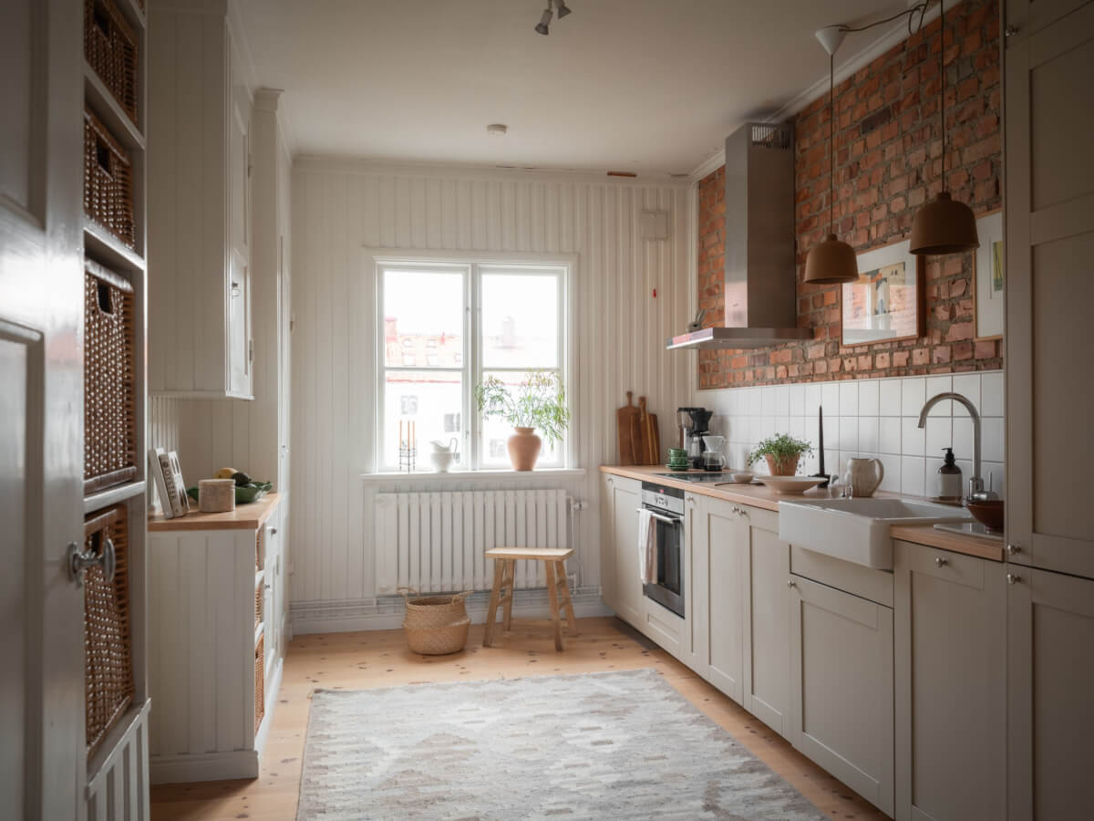 A Renovated Duplex Apartment with Exposed Brick Walls 9 kitchen brick wall wood paneling