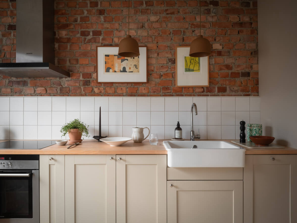 A Renovated Duplex Apartment with Exposed Brick Walls 8 kitchen brick wall