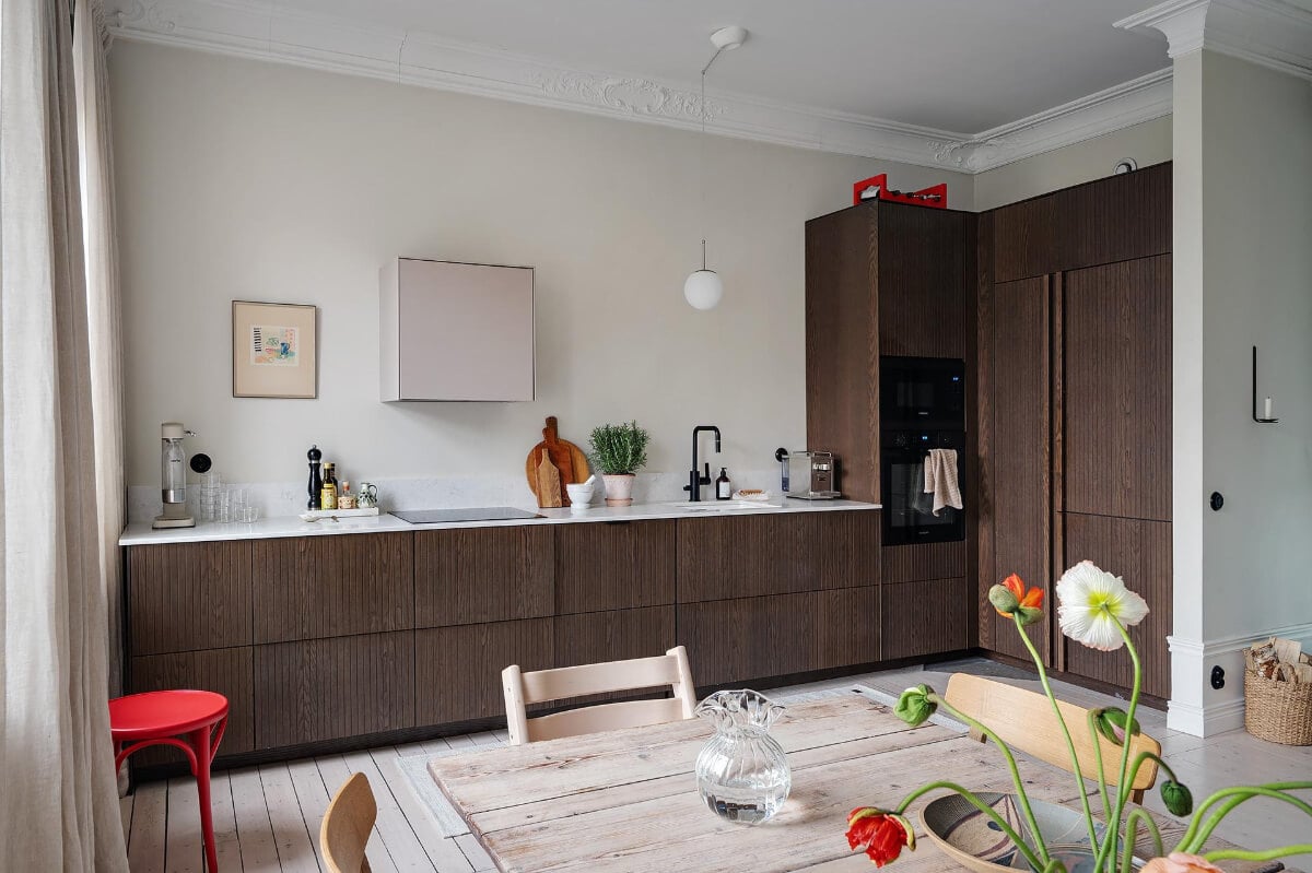 Period Features and Modern Materials in a Swedish Apartment 11 kitchen dark stained ash veneer cupboards